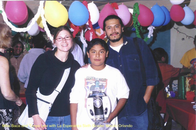 Americas_Foundation_Mike Baca and Tanya Levi help give Christmas Presents